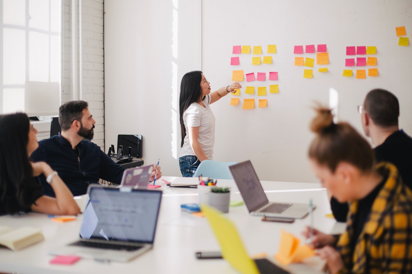 Office team reviewing workflow notes during a software planning session